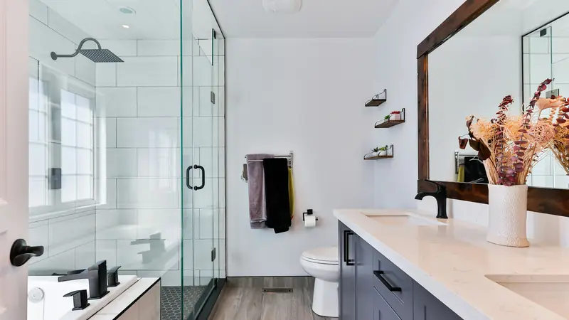 Bright bathroom with a clear glass shower and white vanity